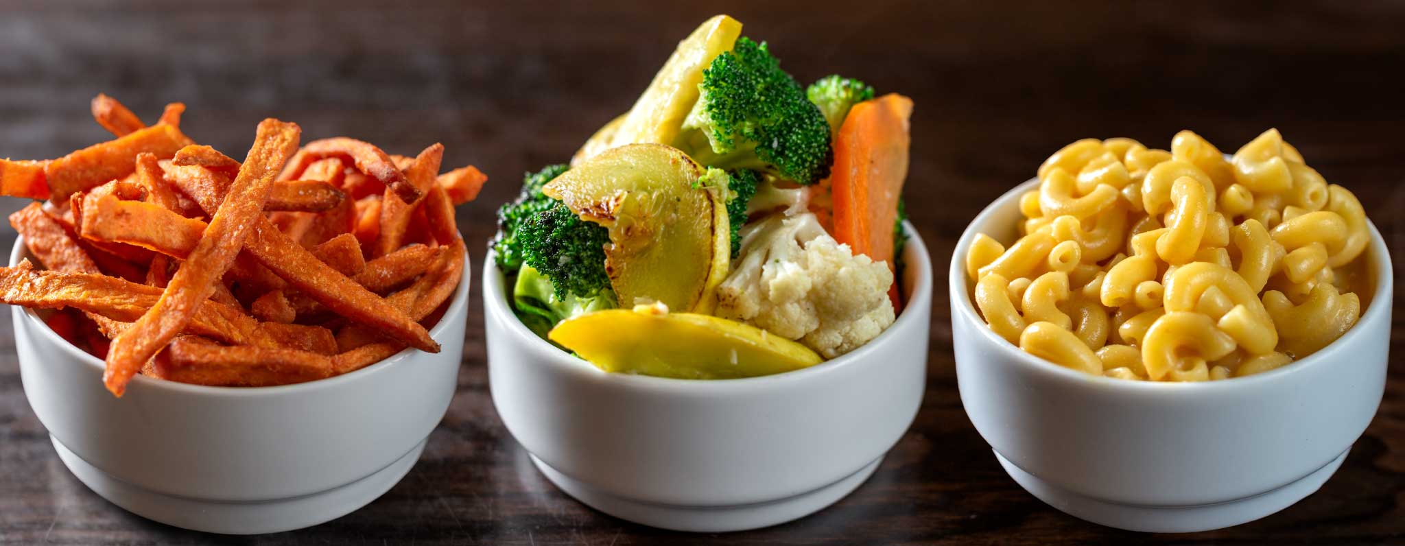 3 popular sides: sweet potato fries, sautéed veggies, Mac 'n Teese® – vegan